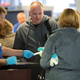 Image for article titled TSA Agent Can’t Bring Himself To Make Dad Take Off Comfy Shoes